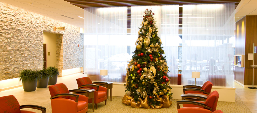 Christmas tree in lobby of healthcare facility.